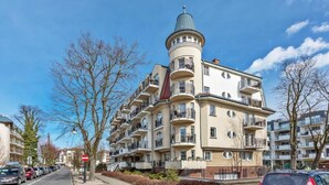 A multi-story residential building with balconies, a tower-like structure, and a clear sky. - Regina Maris by Baltic Home (Swinoujscie)