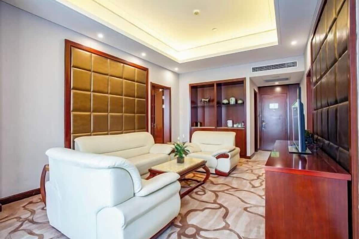 A modern living room with a sofa set, a coffee table, and a TV stand.