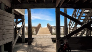 A wooden pedestrian bridge with a bicycle parked on the right. - Direct Beach Access, Pet Friendly & Pool (Cape San Blas)