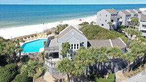 A beachfront property with a swimming pool, multiple buildings, and a beach view. - Direct Beach Access, Pet Friendly & Pool (Cape San Blas)