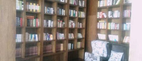 A library with bookshelves and a leather armchair.
