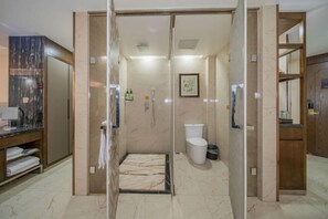 A modern bathroom with a glass shower enclosure, a marble-tiled floor, and a white toilet. - Jianan Business Hotel (Yongzhou)