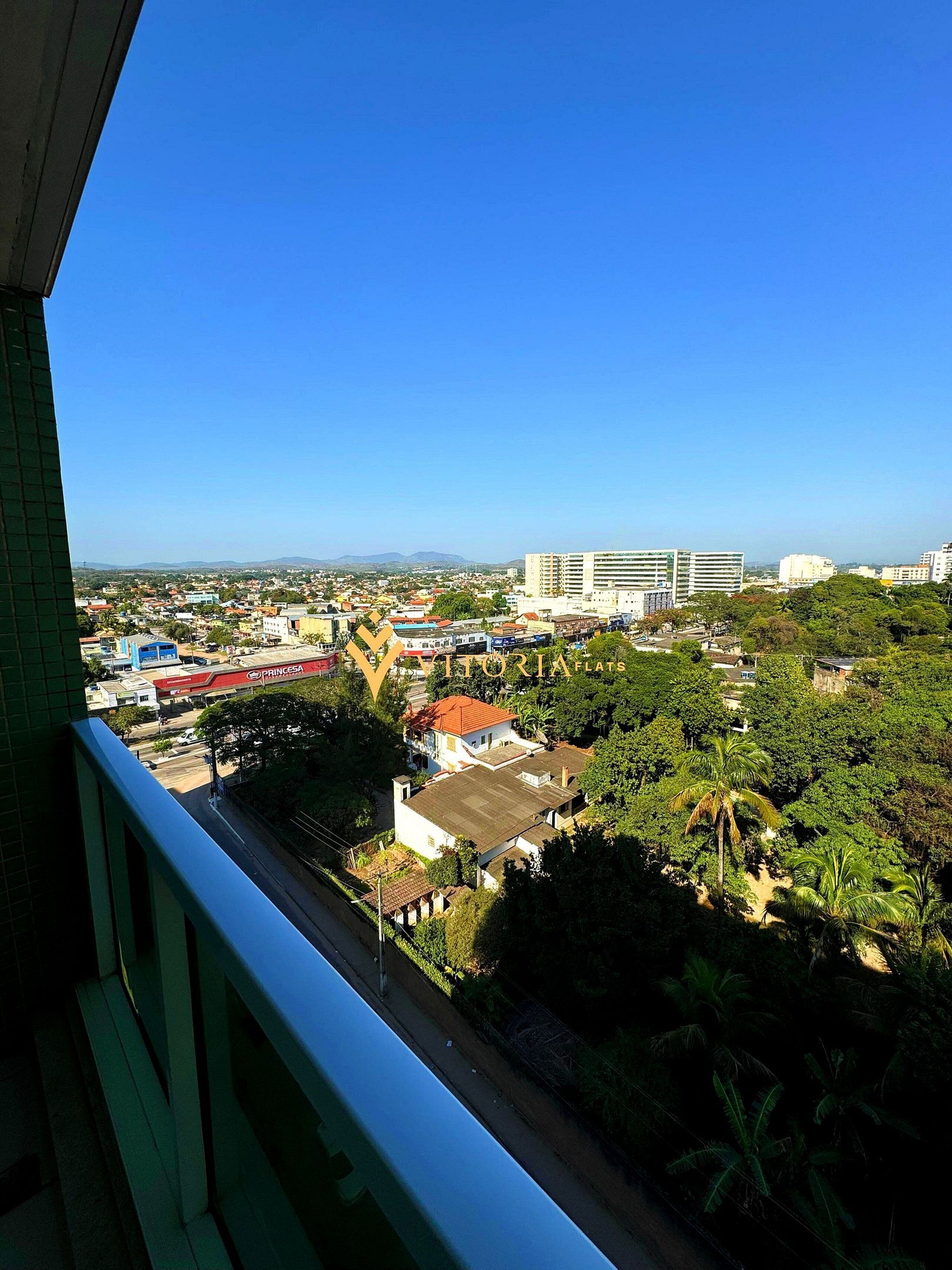 A cityscape with a mix of residential and commercial buildings, a prominent flat building, and lush greenery.