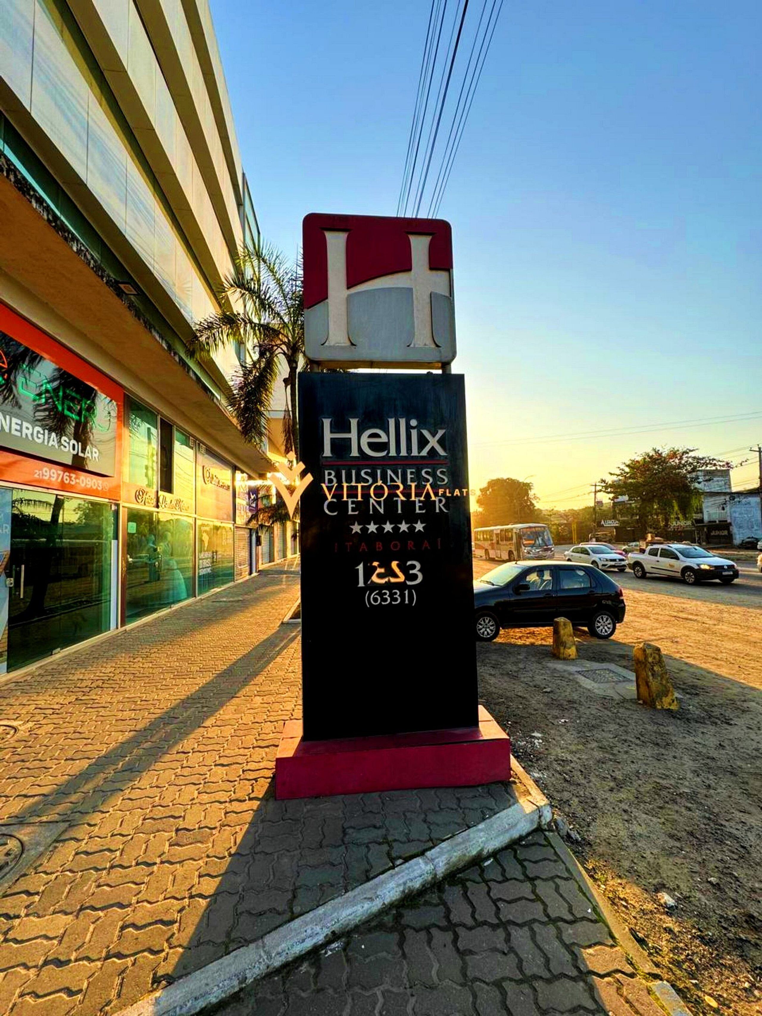 A business center sign with the name 'Hellix Business Victoria Flats' and a phone number.