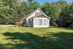 A single-story house with a gabled roof, a covered porch, and a well-maintained lawn.