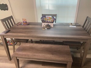 Enjoy meals in this cozy dining area with a wooden table, bench, and plenty of storage for snacks and essentials.