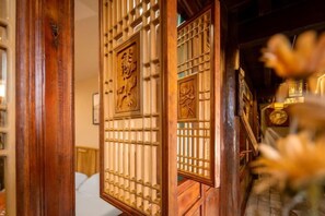 A traditional wooden door with intricate carvings and a lattice design.