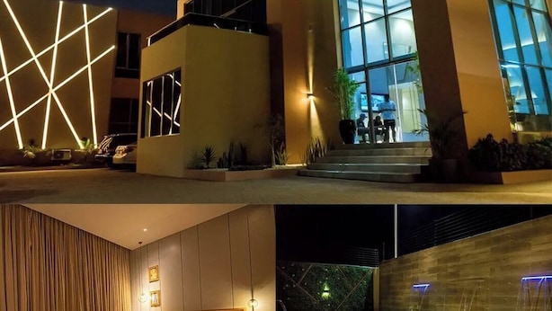 A modern hotel exterior with large windows and geometric light patterns. - 649 Suites (Asaba)