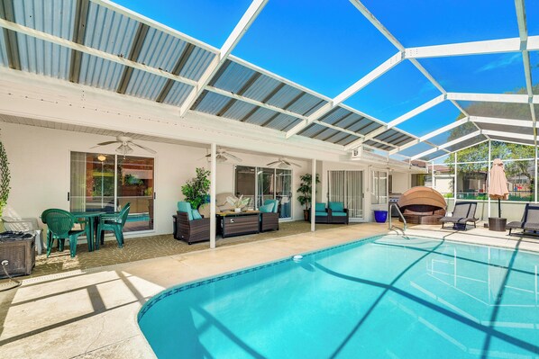 A covered swimming pool area with lounge chairs, a table, and a grill. - 9 Mi to Beach! Poolside Escape in Spring Hill (Spring Hill)