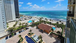 A resort with a pool, beach, and ocean view.
