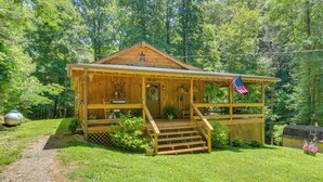 A wooden cabin with a porch, steps, and an American flag. - Private, Secluded Cabin on 30 Acres in Cosby! (Cosby)