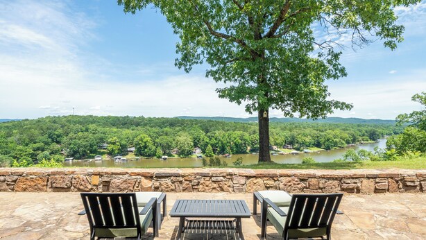 A patio with two chairs and a table, overlooking a river and forested hills. - The Overlook - best views on the lake!  (Hot Springs)