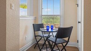 A corner room with a small table and two chairs, a window with blinds, and a door. - The Overlook - best views on the lake!  (Hot Springs)
