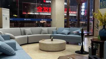 A modern living room with a sectional sofa, a round coffee table, and a small side table.