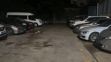 A parking lot with multiple cars parked in rows.