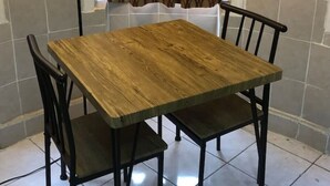 A dining table with four chairs, a floor lamp, and a patterned curtain. - Private 1-bedroom apartment, 15 minutes to Manhattan, NYC bus at the door (Union City)