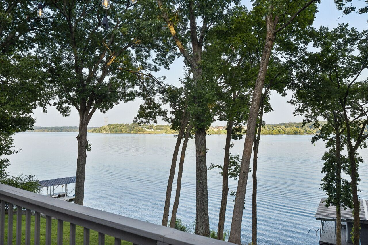 A lake view with trees and a dock.