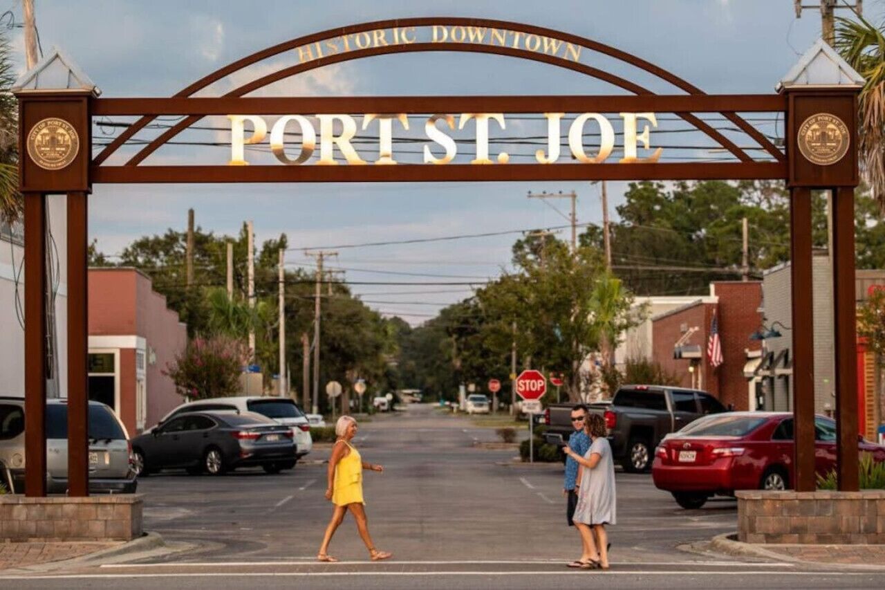 A street sign for Port St. Joe with a historic downtown arch.