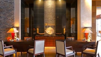 A dining area with a long table, chairs, and a decorative centerpiece.