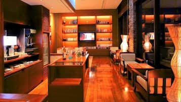 A modern interior with a bar area, seating, and a television.