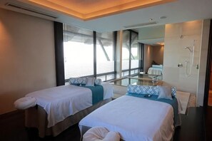 Une chambre d’hôtel avec deux lits, un grand miroir, une douche et une vue sur l’extérieur.