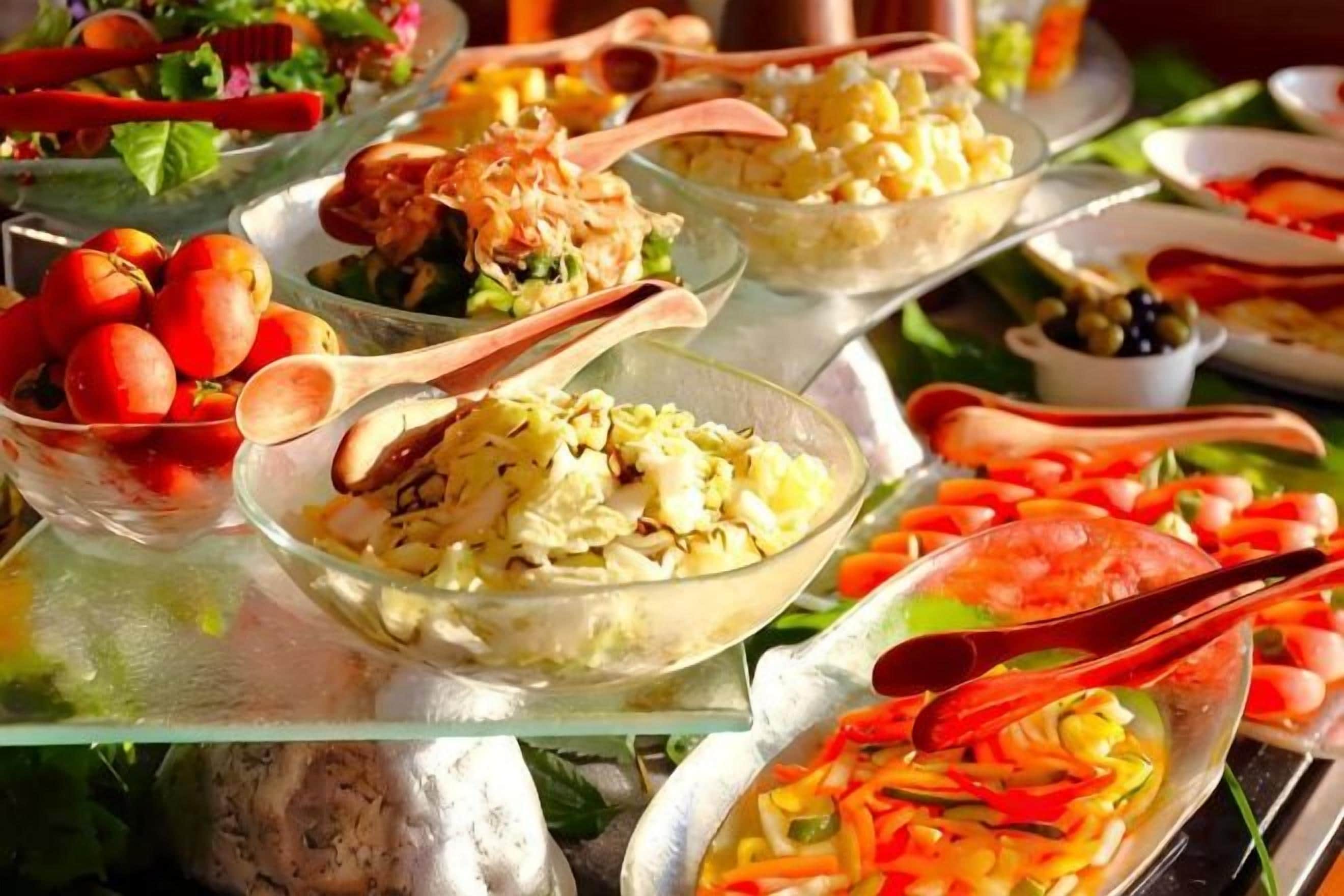 A buffet with various dishes and serving utensils.