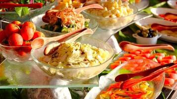 A buffet with various dishes and serving utensils.