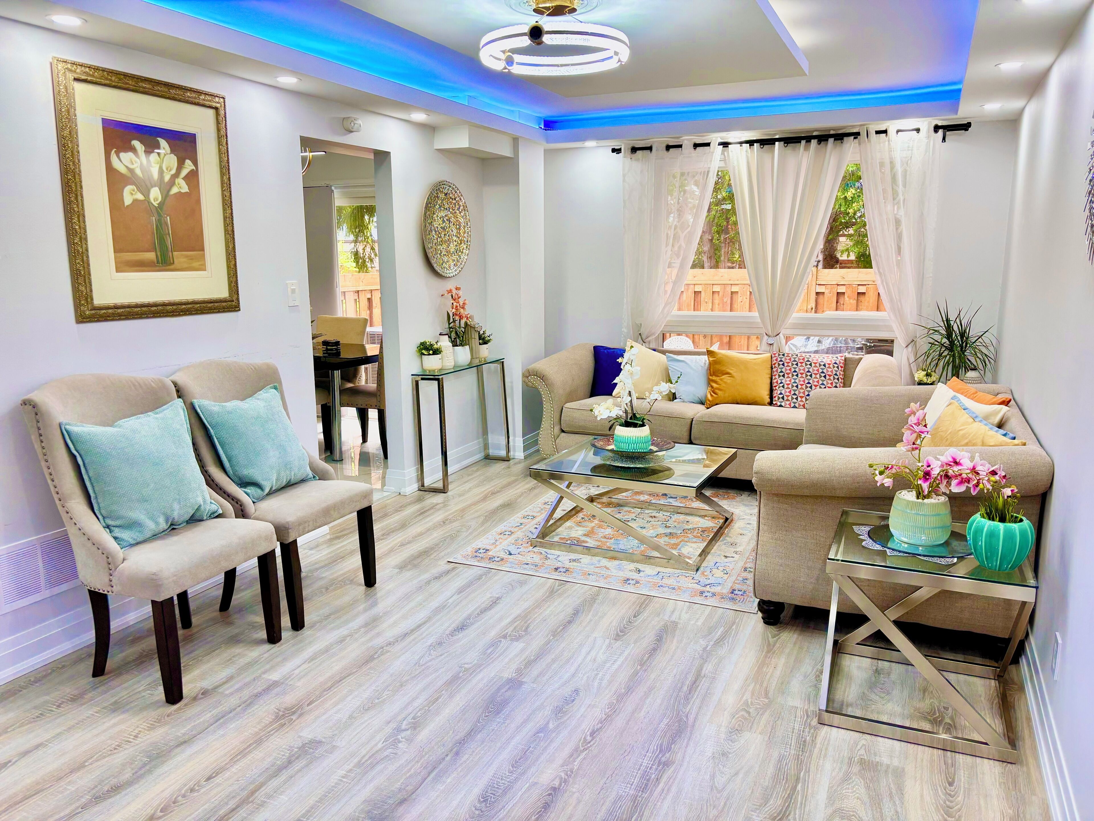 A modern living room with a sofa, armchairs, a coffee table, and decorative vases.