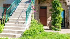 A stone building with a staircase leading to a balcony. - 2-person rental in Les Badieux (BONDONS (LES))