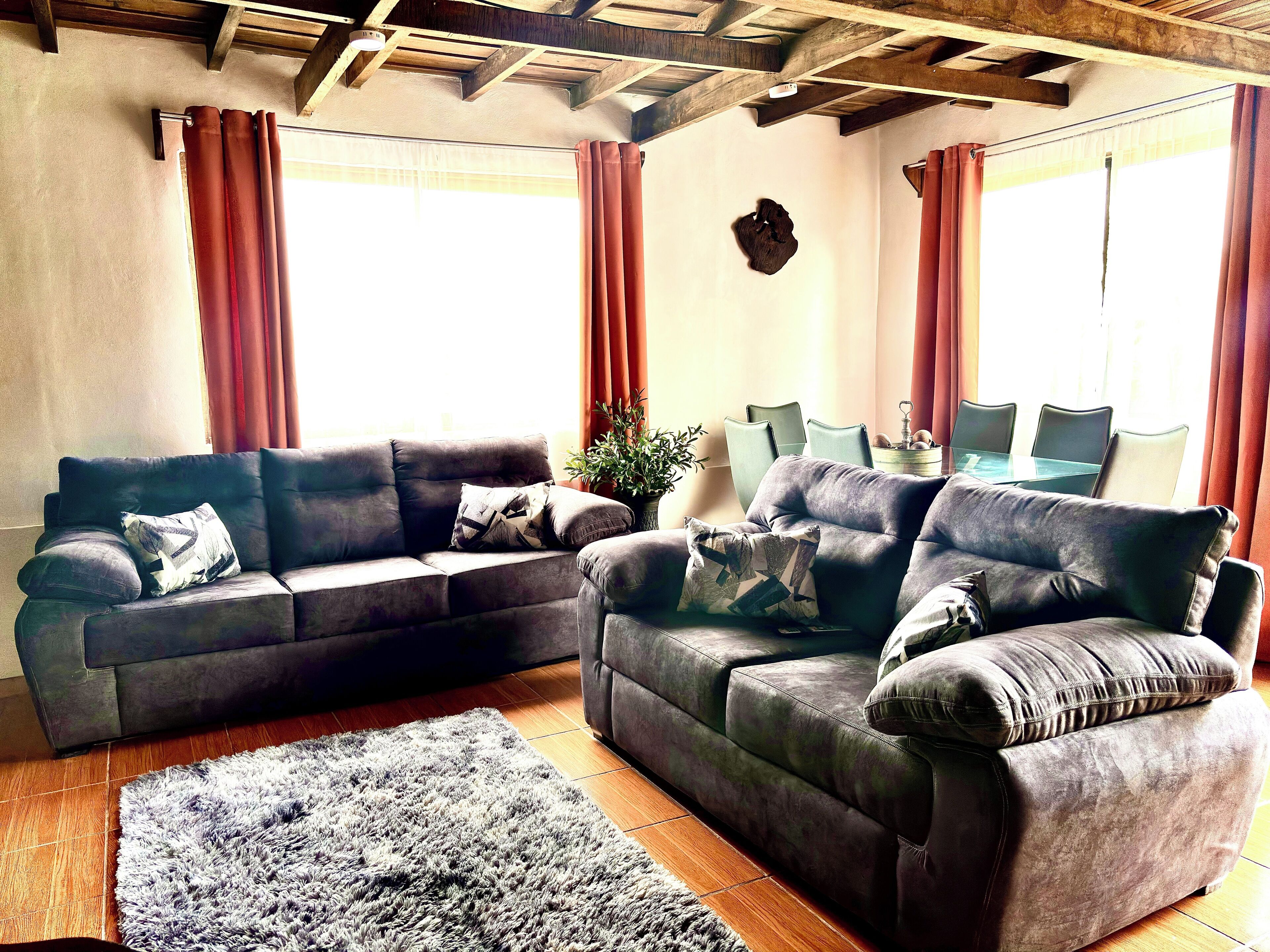 A living room with two sofas, a coffee table, and a rug.
