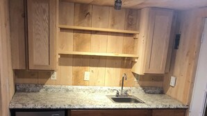 A kitchen with wooden cabinets, a granite countertop, a stainless steel sink, and a built-in refrigerator. - Chateau Tina in the Mountains AC, Dog Friendly East Durham N (East Durham)