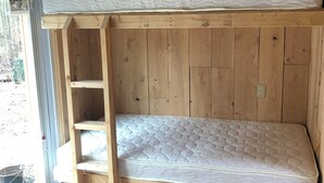 A bunk bed with a wooden ladder, a shelf above, and a view of the outside. - Chateau Tina in the Mountains AC, Dog Friendly East Durham N (East Durham)