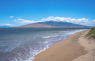 On the beach, white sand, beach umbrellas, beach towels