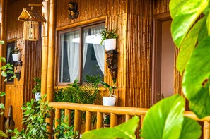 A bamboo exterior with a window, potted plants, and a railing. - Sky Garden Homestay (Olongapo)