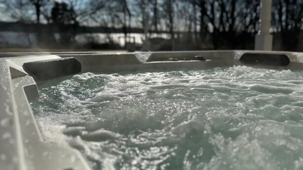 Un bain à remous avec vue sur les arbres et un ciel dégagé.