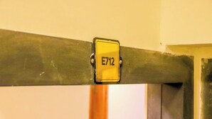A metal beam with a yellow sign labeled "E712". - Studio Sleeps 2 with 24hr Check-in (Nairobi)