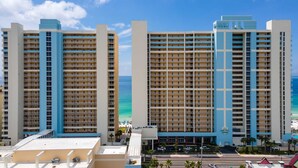 A high-rise hotel with multiple floors, balconies, and a view of the ocean. - Shoreline Serenity by Avantstay Beachfront + Views! (Panama City Beach)