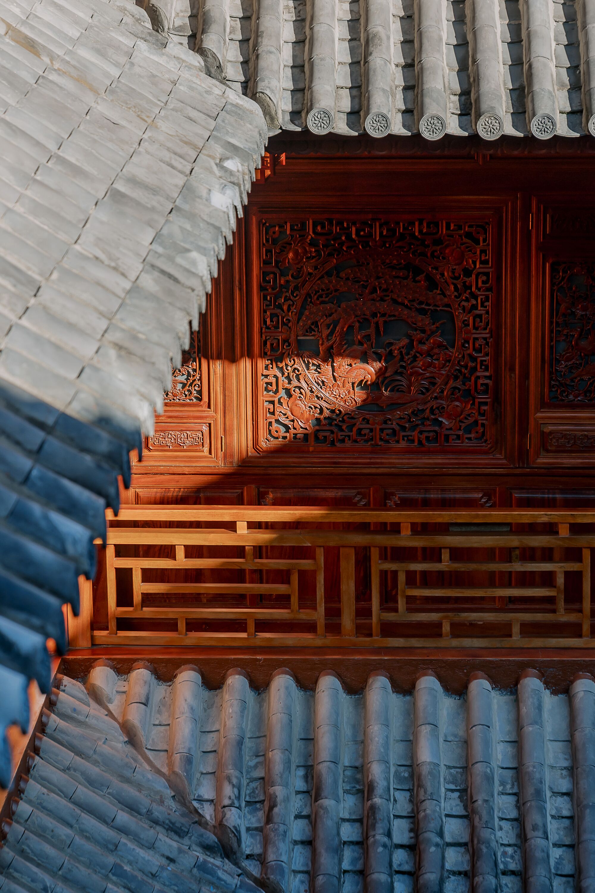 A traditional building with a tiled roof and intricate wooden carvings.