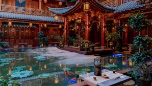 A traditional courtyard with a pond, tiled roof structures, and lanterns. - Spirited Silky Inn (Dali)