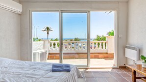 A bedroom with a bed, a window, and a view of the sea. - Vacation home Playa by Interhome (Empuriabrava)