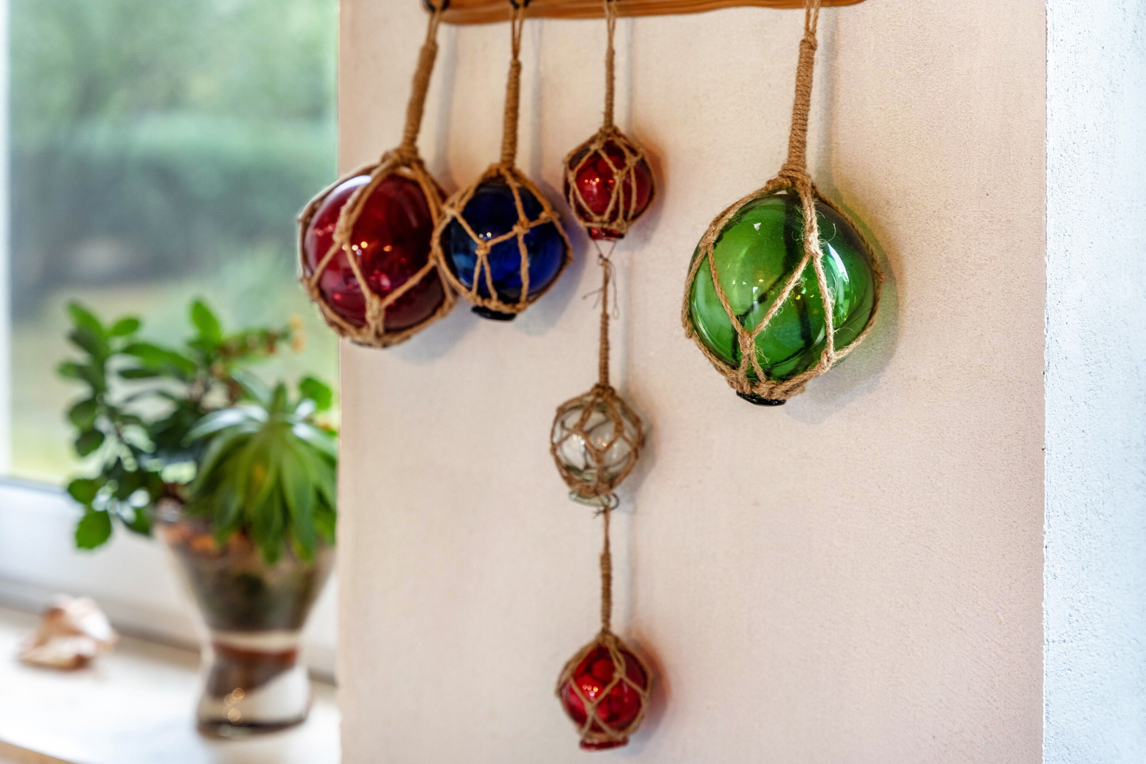A wall-mounted decoration with various colored glass ornaments.