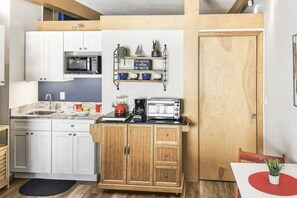 Fridge, microwave, coffee/tea maker, cookware/dishes/utensils