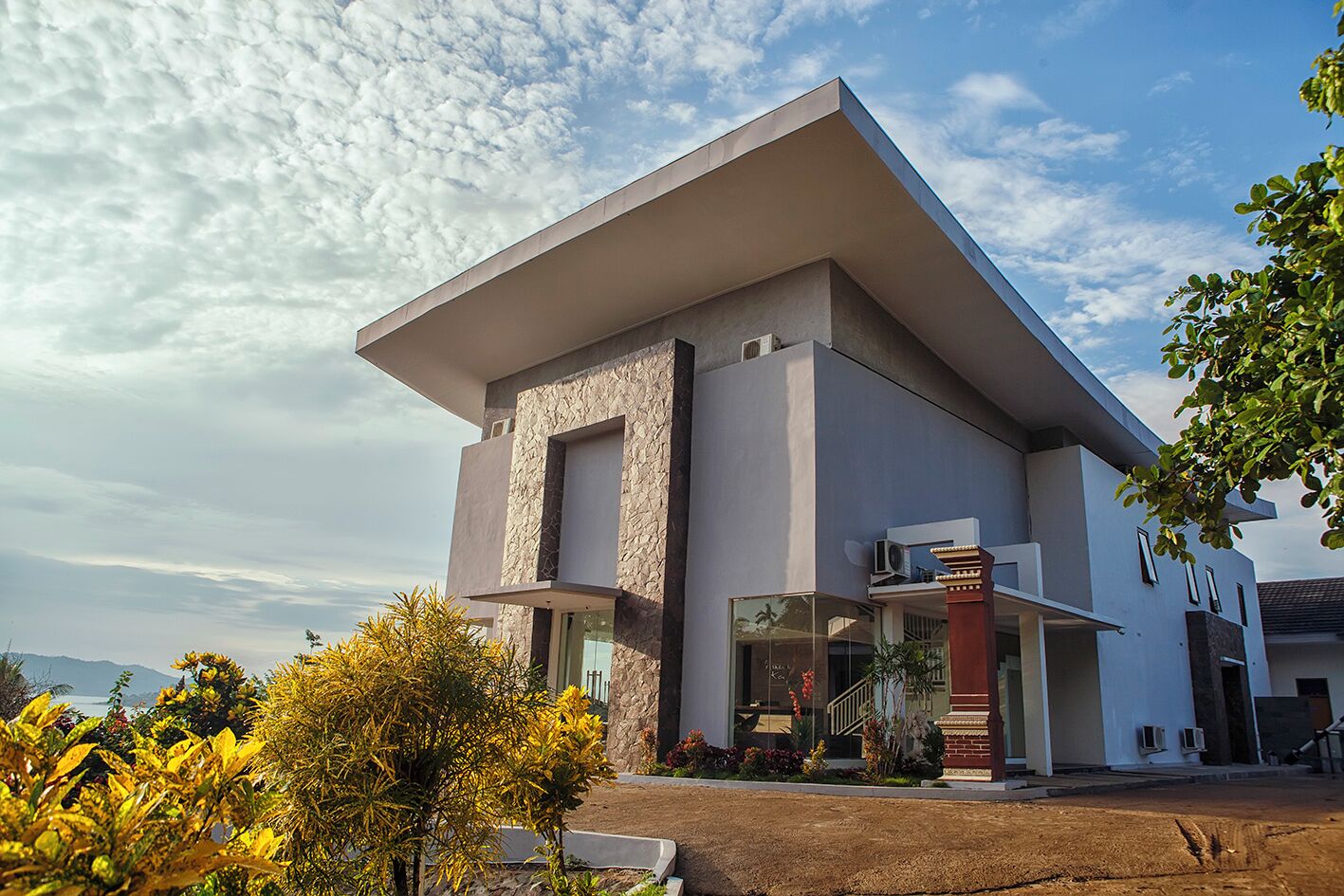 A modern two-story house with a flat roof and large windows.