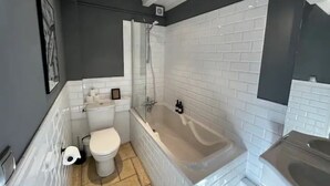 A bathroom with a toilet, bathtub, and shower. - Idyllic Village Cottage With Hot Tub & Scenic Views (Mont-Saint-Jean)