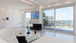 Un soggiorno moderno con un'ampia finestra, una TV a schermo piatto e un design minimalista.