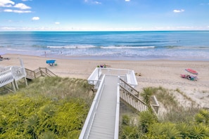 A wooden boardwalk leading to a beach with clear skies and calm waters. - Meant To Be - Oceanfront 5 BR home with elevator! (Surf City)