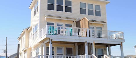A two-story building with a balcony on the upper level.