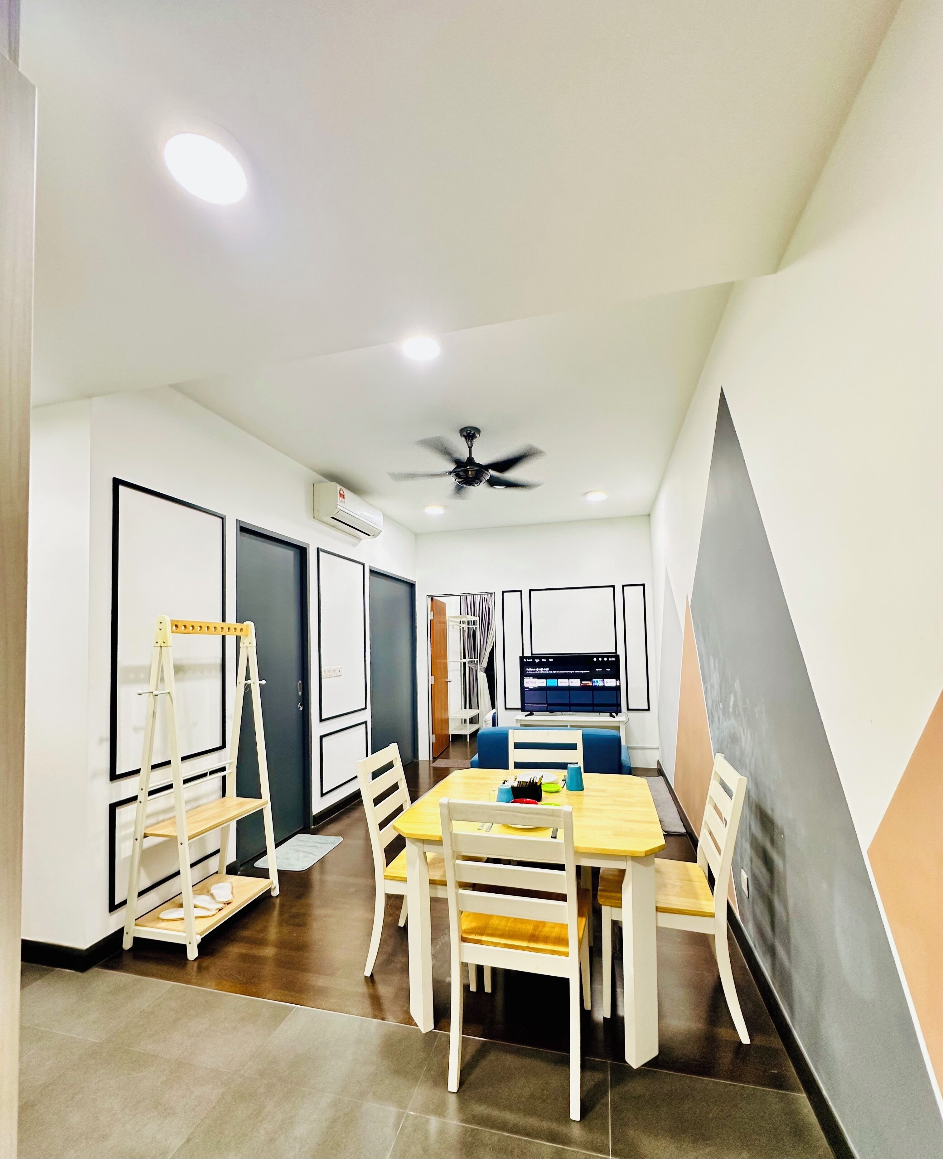 A modern dining area with a table, chairs, and a ceiling fan.