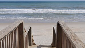A wooden boardwalk leading to a beach with waves in the background. - Wholly Mackerel - Oceanfront, 2 Bedroom, Adorable Cottage in Surf City!  Dog (Surf City)