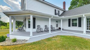 A two-story house with a covered porch and a landscaped yard. - Peaceful Lenoir Home w/ Valley & Mountain Views! (Lenoir)